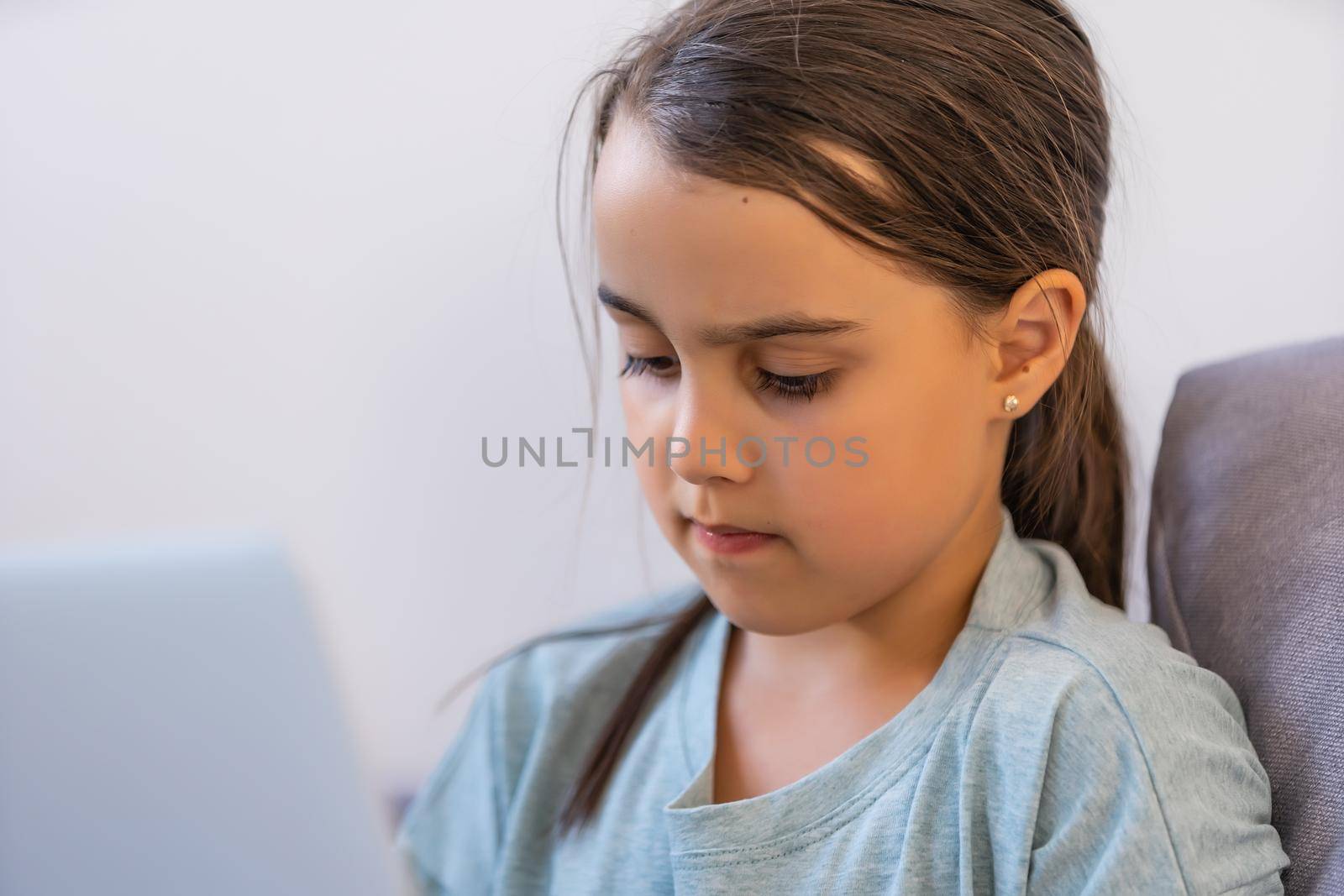 Little Girl Using Digital Laptop E-learning Concept. little girl children using laptop computer, studying through online e-learning system. by Andelov13