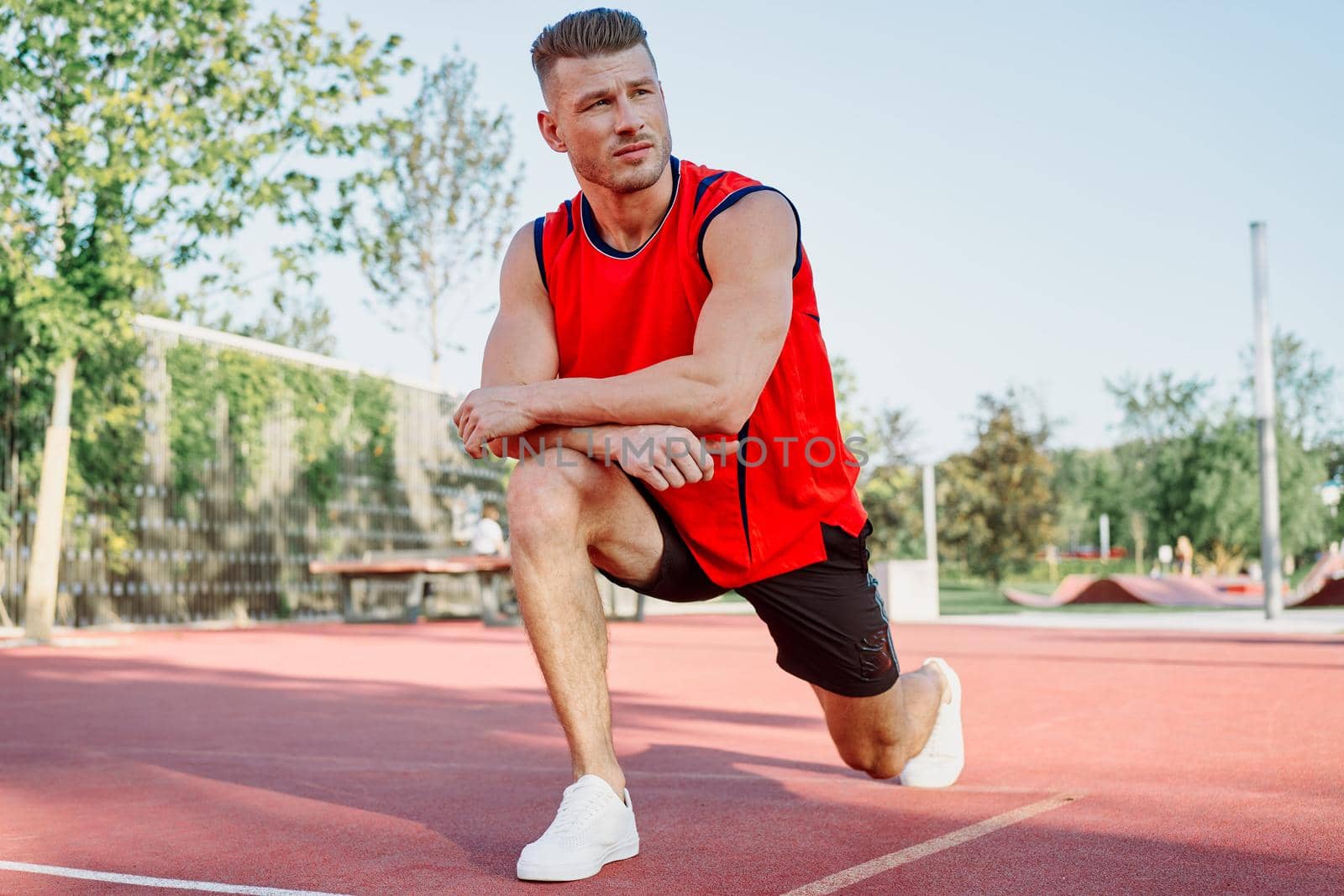 Muscled athletic men on the sports ground workout exercises. High quality photo