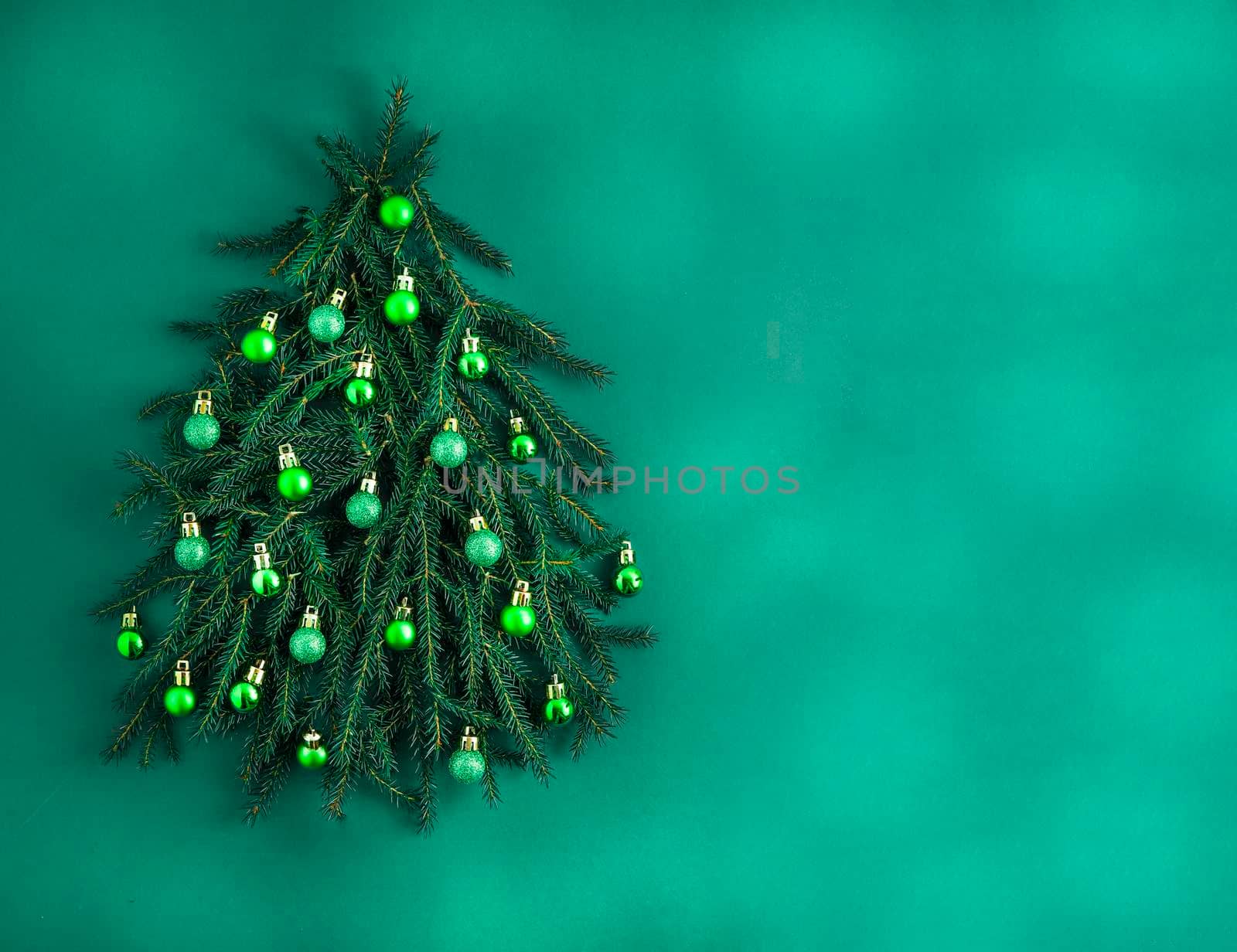 Christmas green background. Pine branches, needles and Christmas tree. View from above. Nature. December mood Green balls