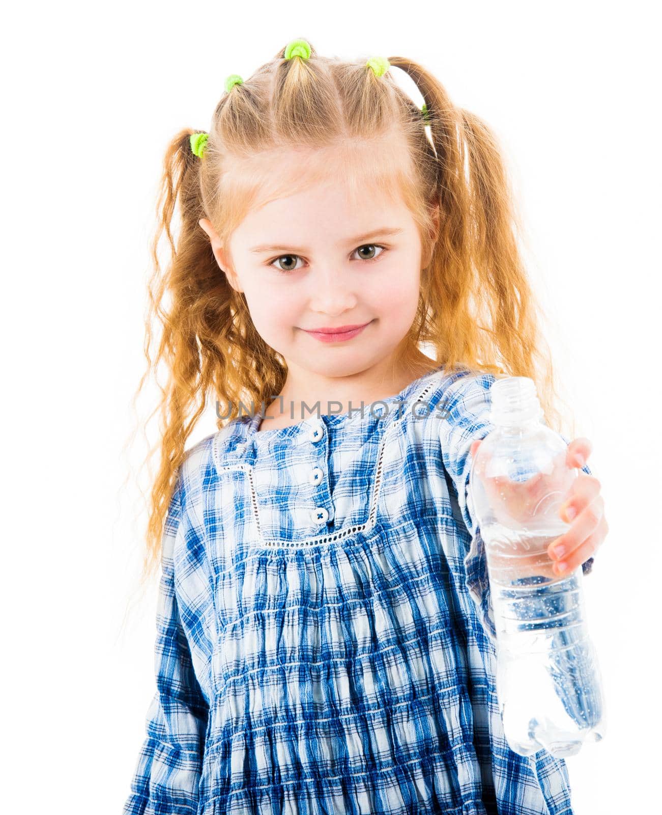 Little child girl holding open bottle of mineral water isolated on white background