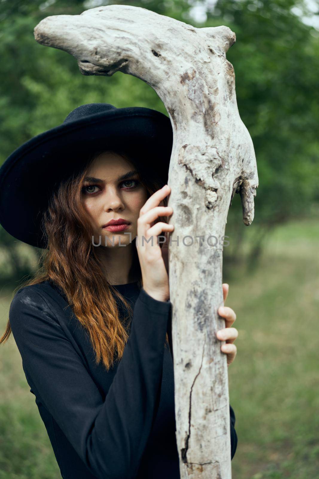 woman in witch costume halloween forest staff gothic. High quality photo