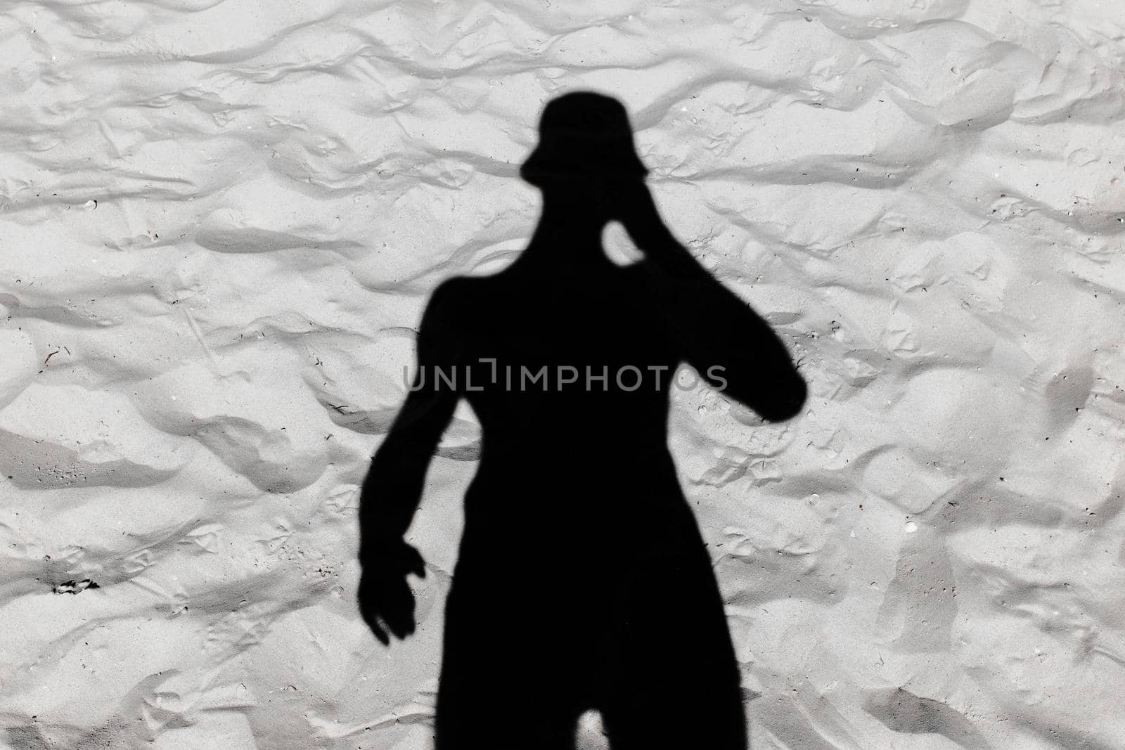 Black male silhouette shadow on white beach sand background by AYDO8