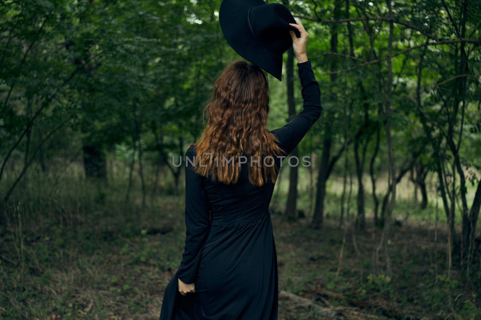 cheerful woman witch in the forest posing fantasy. High quality photo