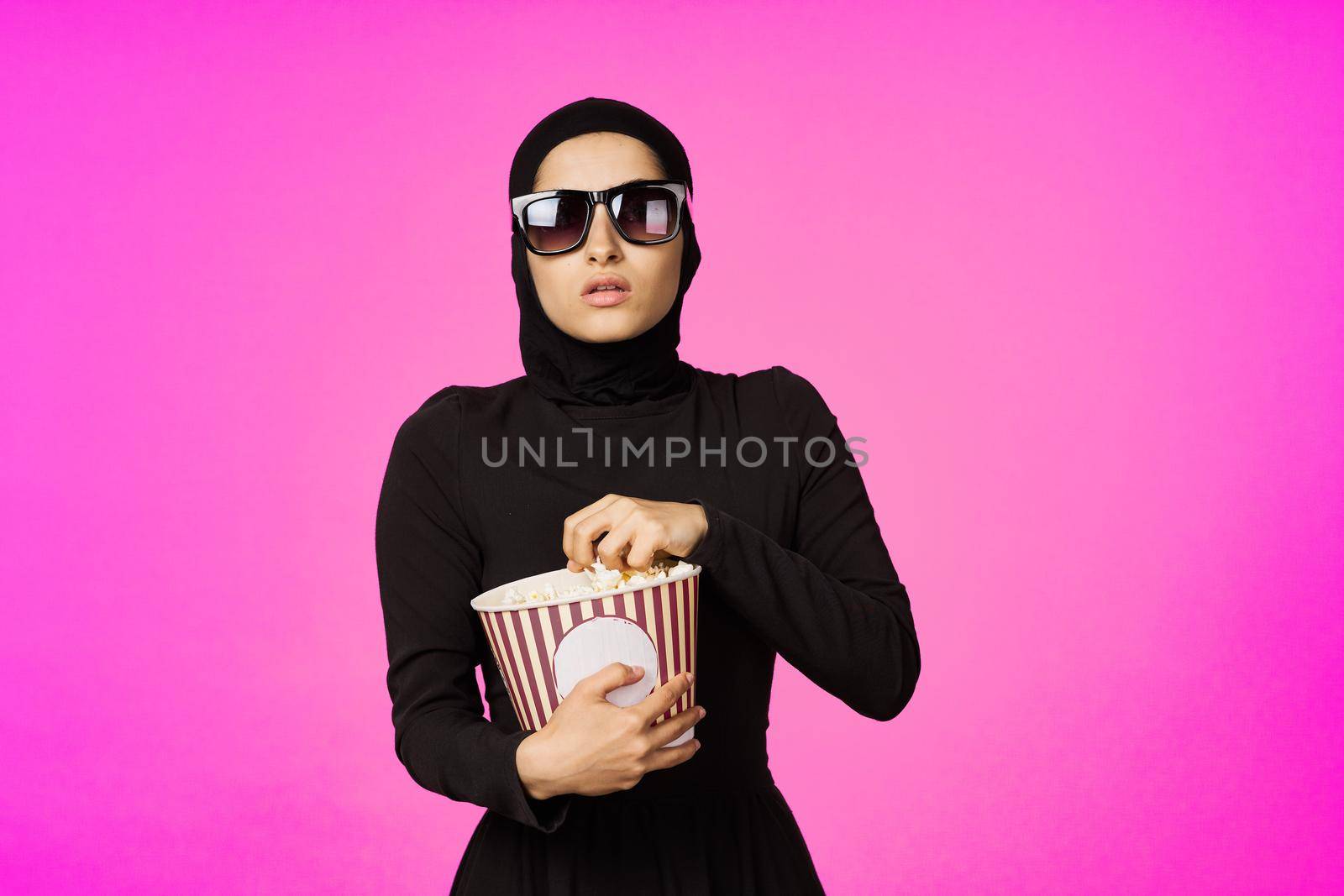 pretty woman attractive look popcorn glasses movie watching studio lifestyle by Vichizh