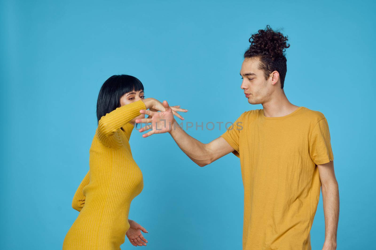 kinky guy and girl together friendship fun blue background. High quality photo