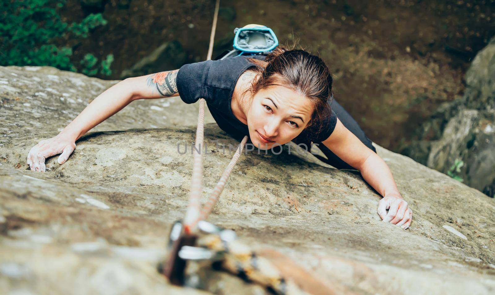 Woman climbing on cliff by alexAleksei