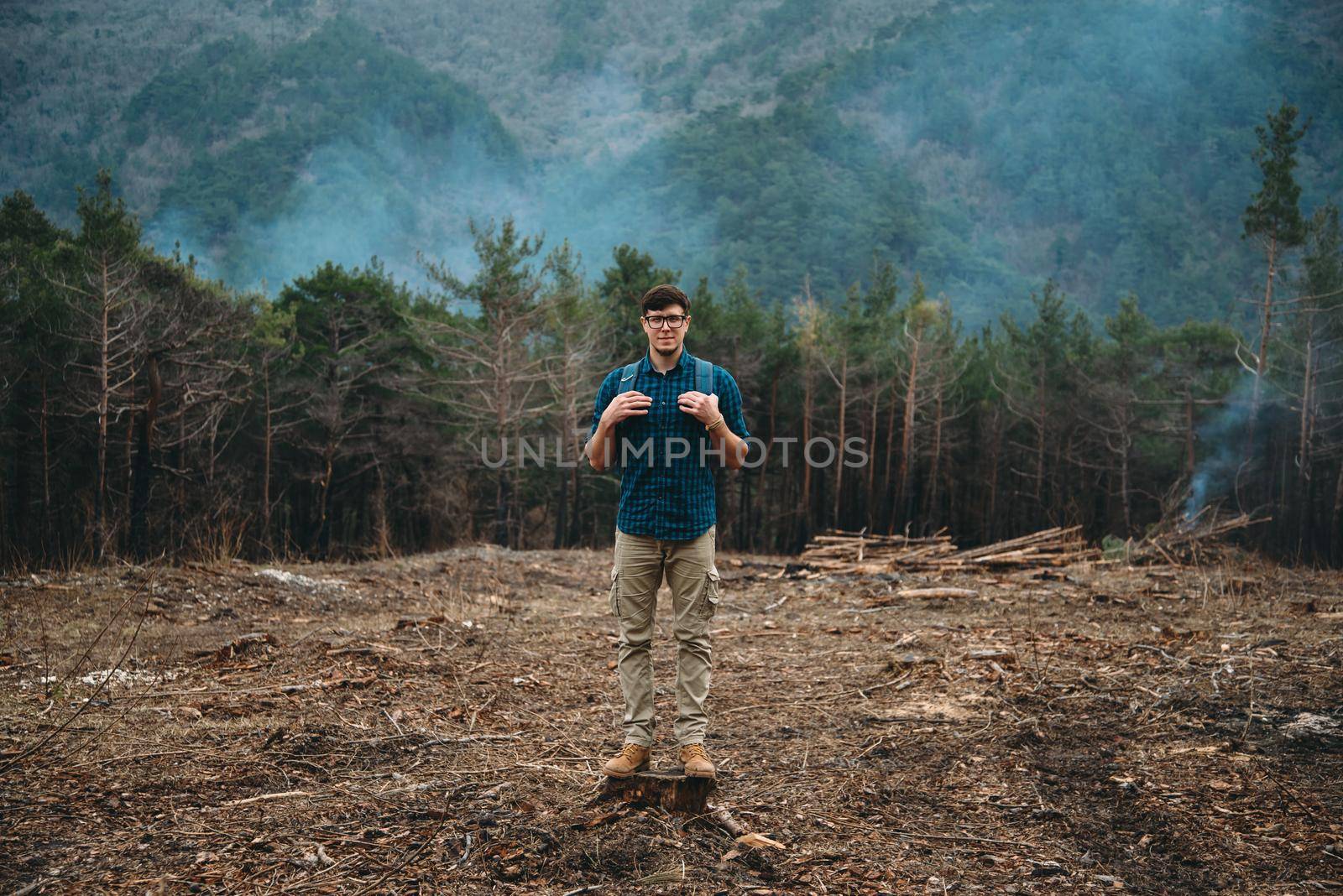 Traveler standing on tree stump by alexAleksei