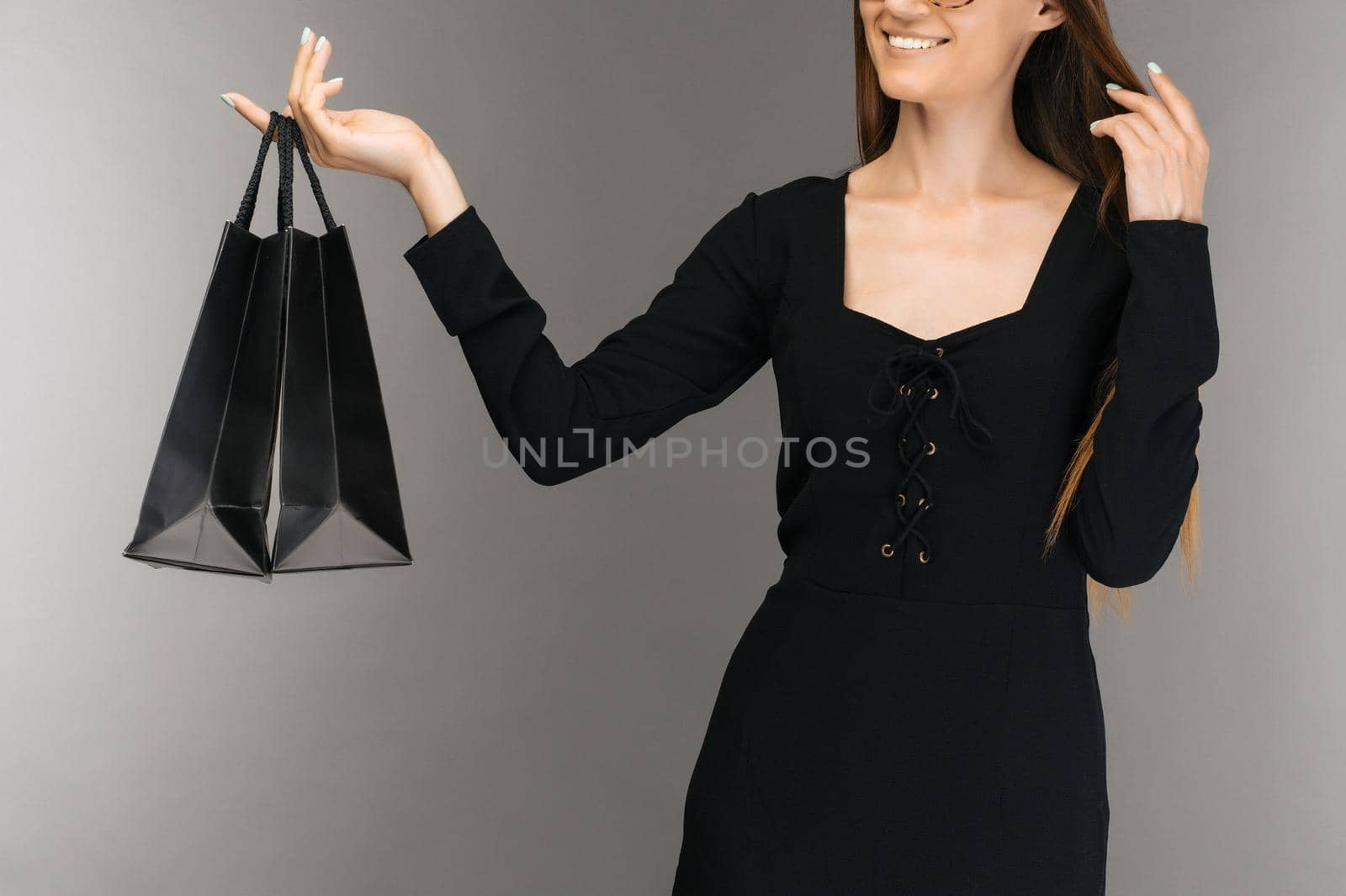 Black friday sale concept. Shopping woman holding bag isolated on background in holiday - Image