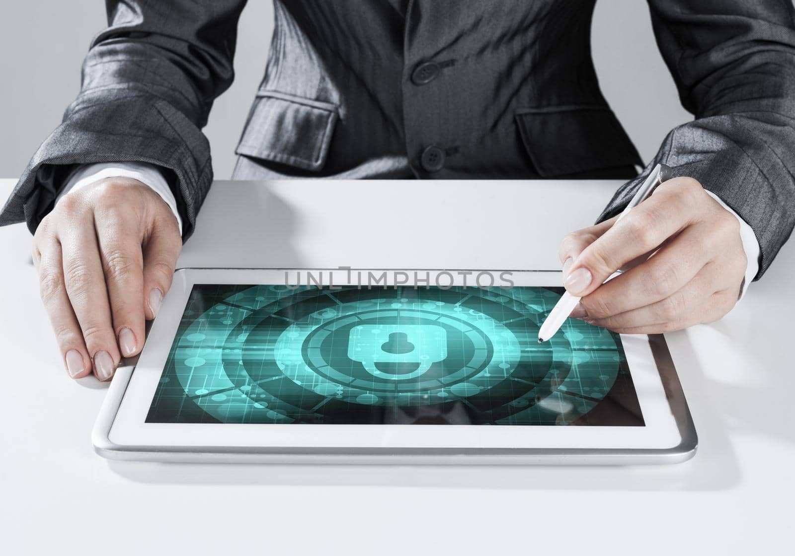 Close up of businesswoman sitting at atble and working on tablet pc