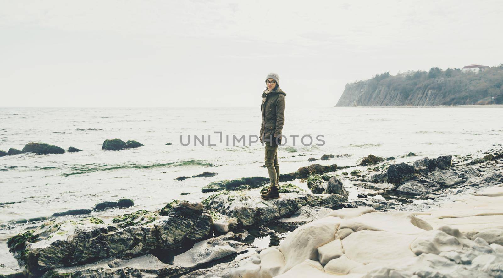 Woman standing on shore by alexAleksei