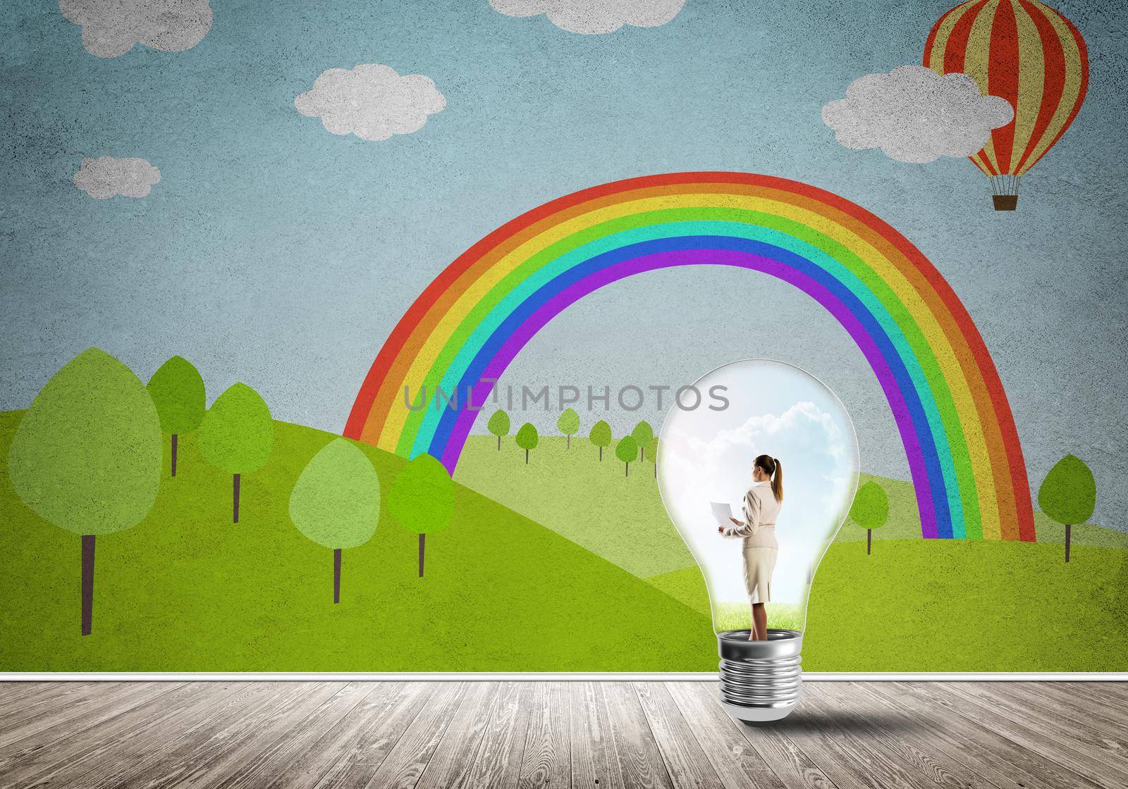 Businesswoman inside light bulb in room against nature drawn concept