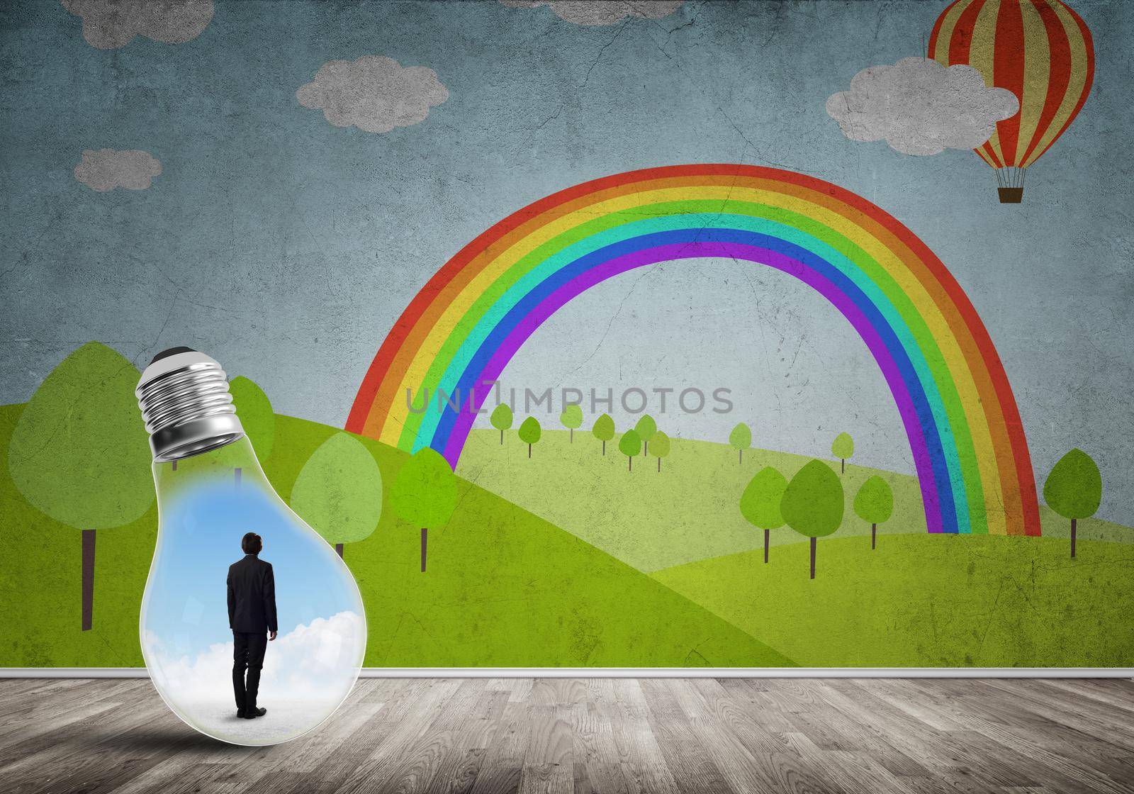 Businessman inside light bulb in room against nature drawn concept