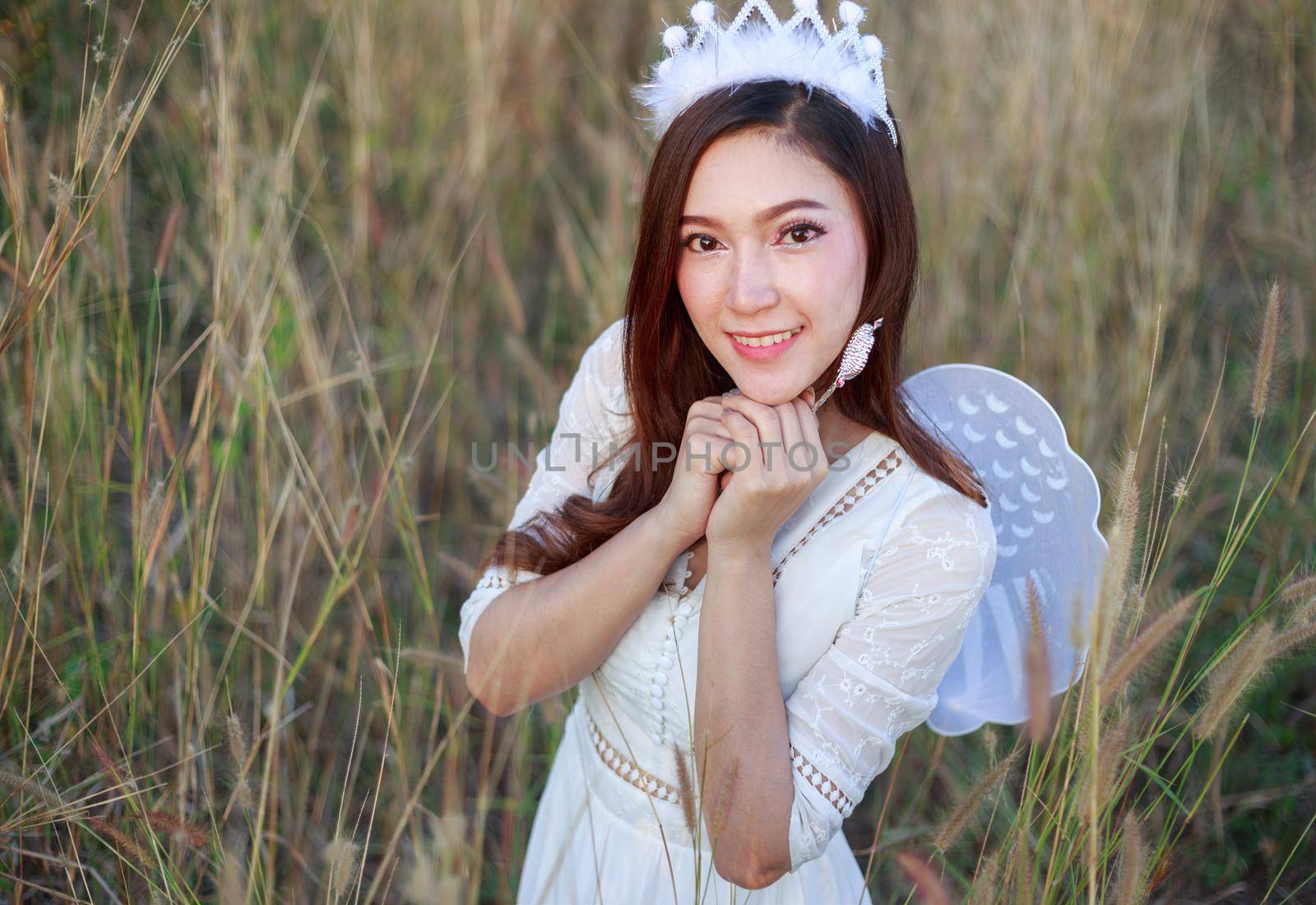 beautiful angel woman in a grass field 