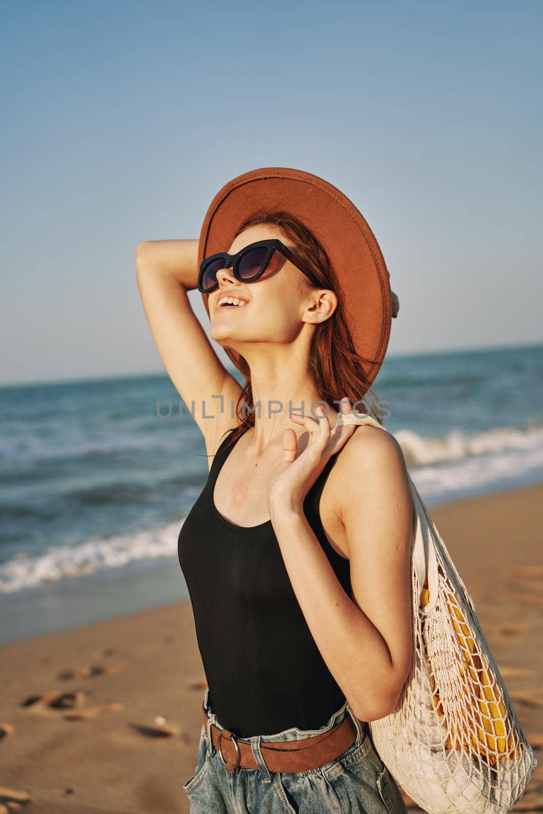 woman walking on the beach landscape sun fun lifestyle. High quality photo