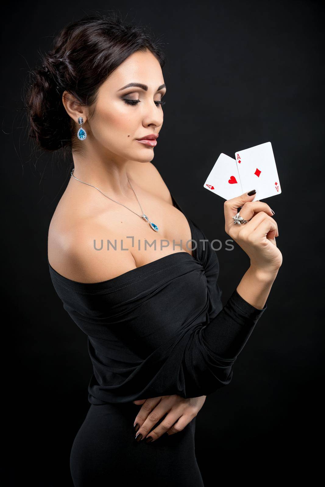 sexy woman with poker cards. Female player in a beautiful black dress. two aces