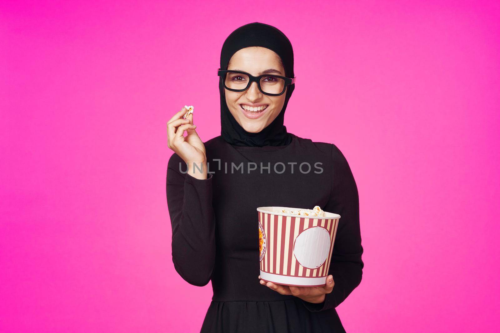 arab woman attractive look popcorn glasses movie watching isolated background. High quality photo