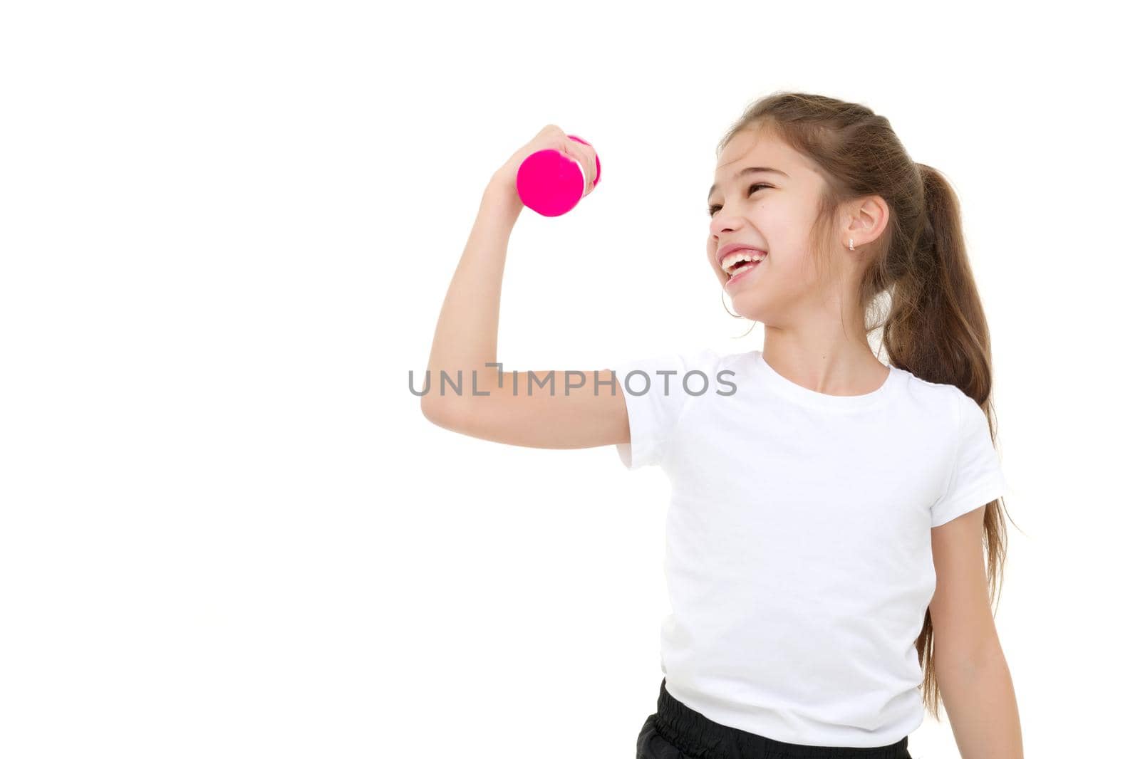 A cute little girl doing exercises with dumbbells. The concept of strength, health and sport. Isolated on white background.