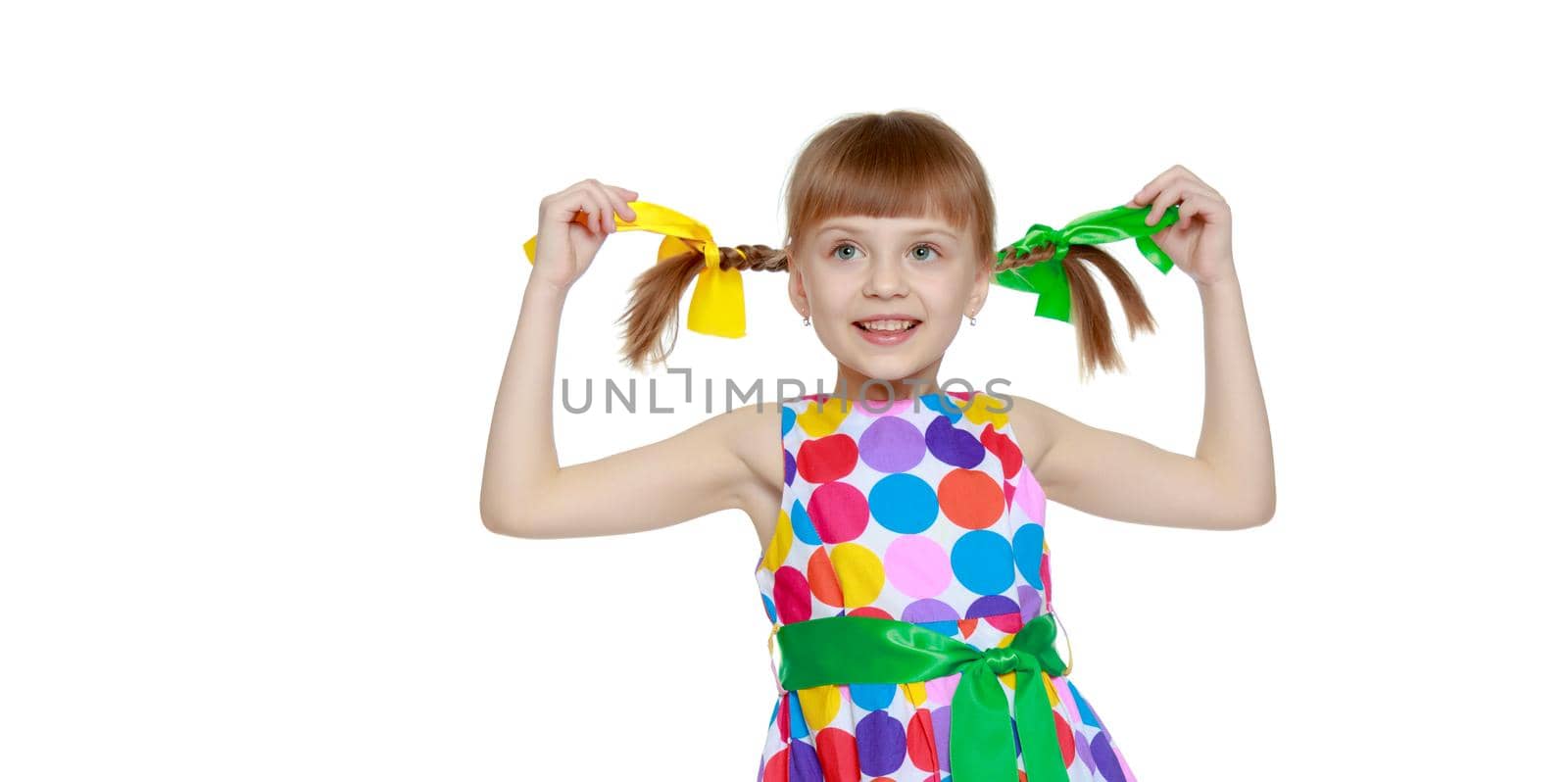 A sweet little blonde girl with long pigtails, in which large colored bows are braided, and a short bangs on her head. In a short summer dress.