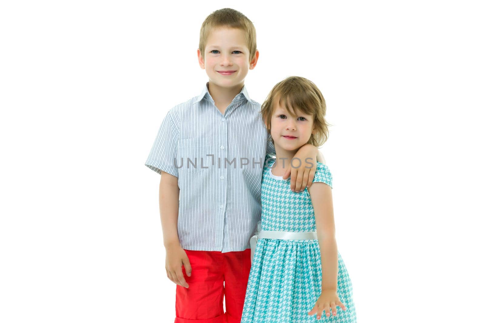Boy and girl, brother and sister posing in the studio. Concept of family values, friendship, game. Isolated on white background