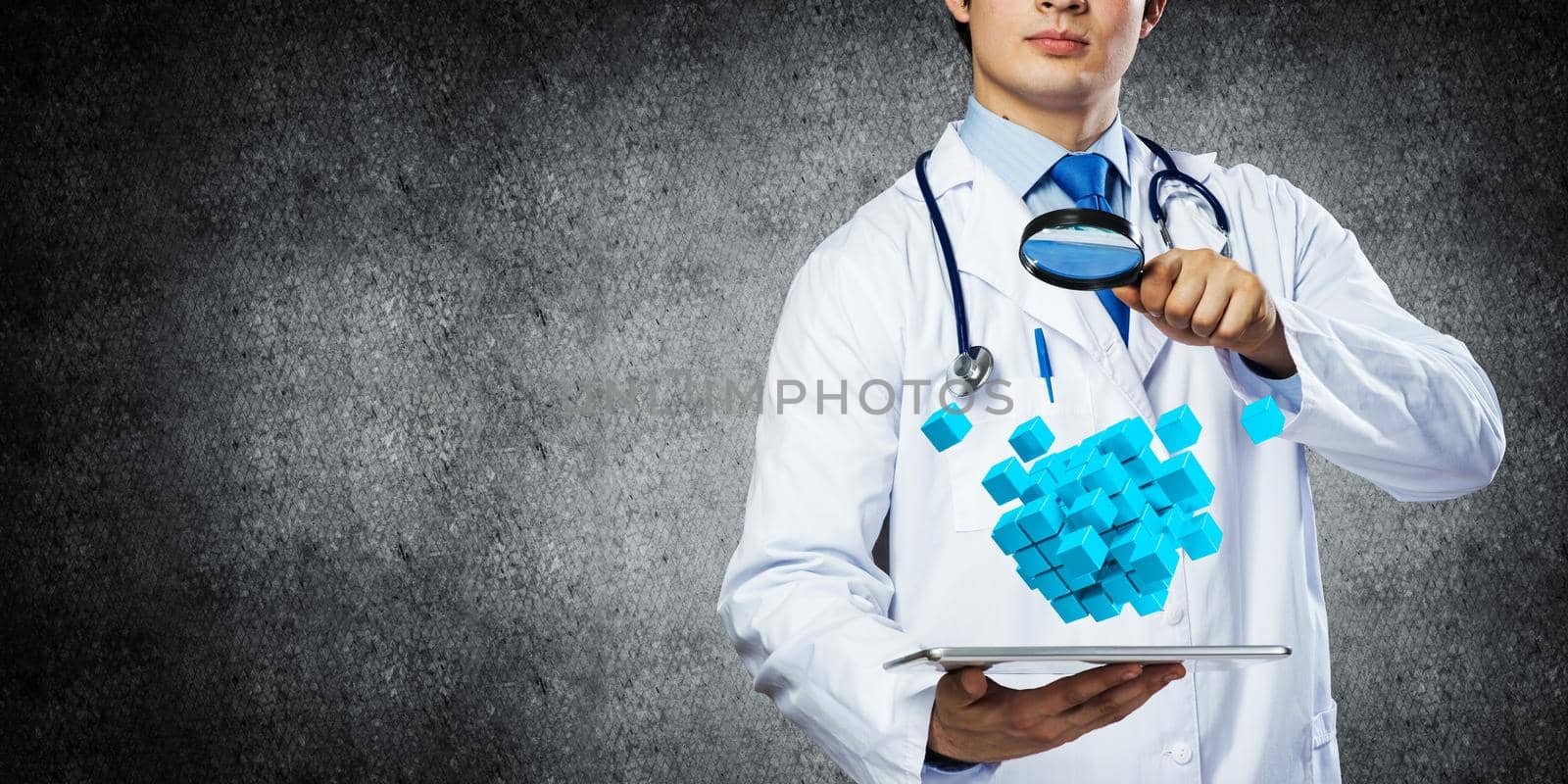 Close up of confident doctor in white sterile suit and with stethoscope looking through magnifier at multiple cubes while standing against gray background.