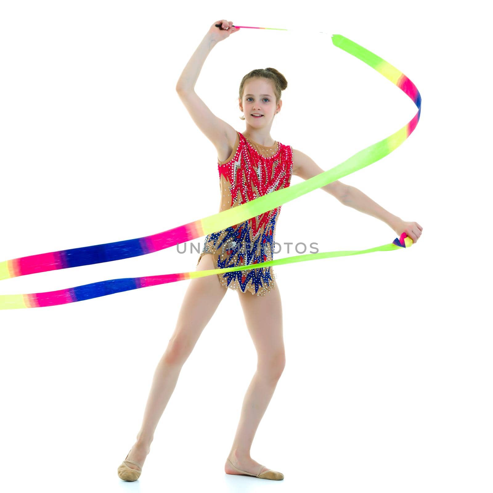 Little girl gymnast performs exercises with tape. The concept of sport, competition. Isolated on white background.