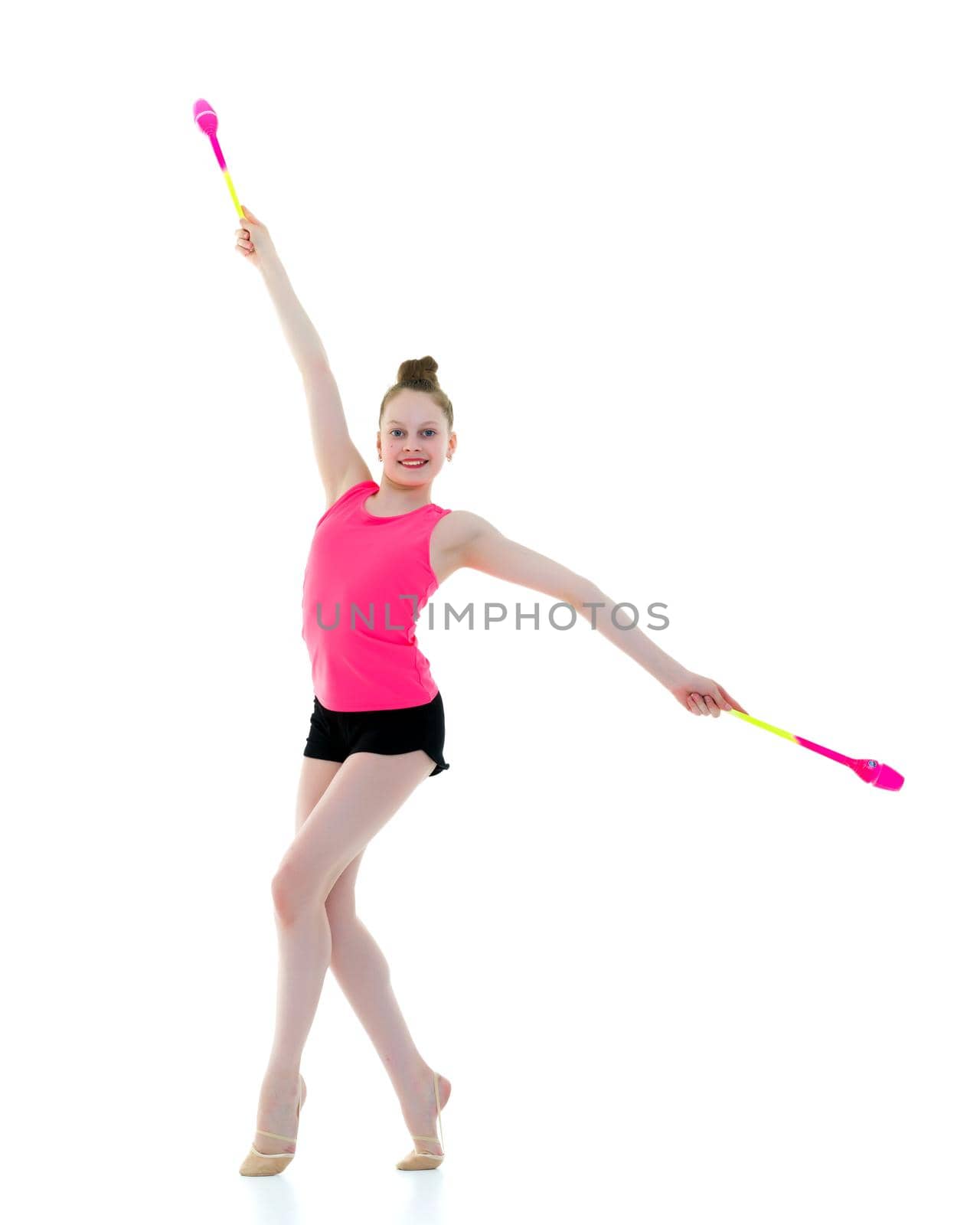 Beautiful little girl gymnast performs exercises with a mace. The concept of children's sports, fitness. Isolated on white background.