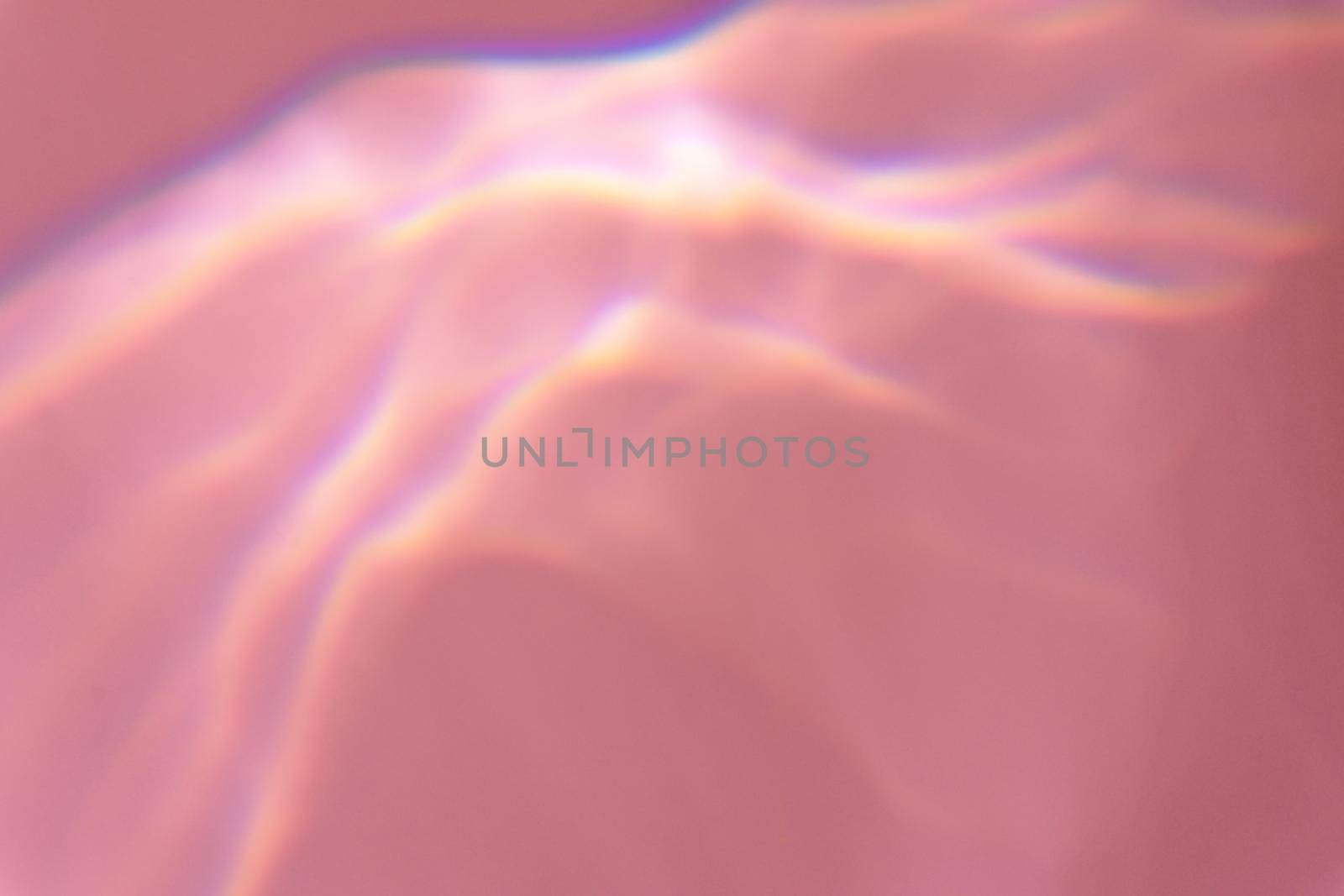 Beautiful lights and shadows of glass on pink or purple background. Overlay mode. Caustic effect of light. Sun hard reflection. Shadows texture. Blurred water backdrop. Top view. Trendy concept