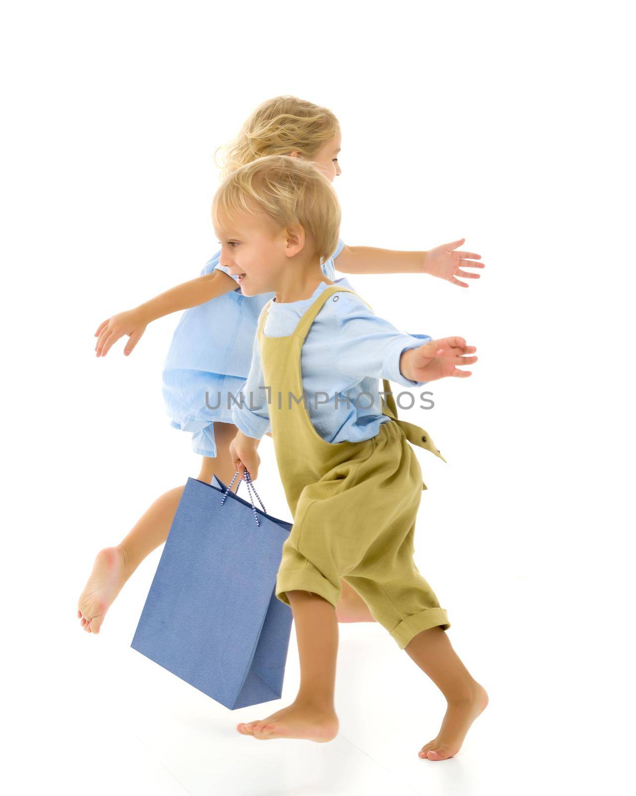 Boy and girl, brother and sister posing in the studio. Concept of family values, friendship, game. Isolated on white background