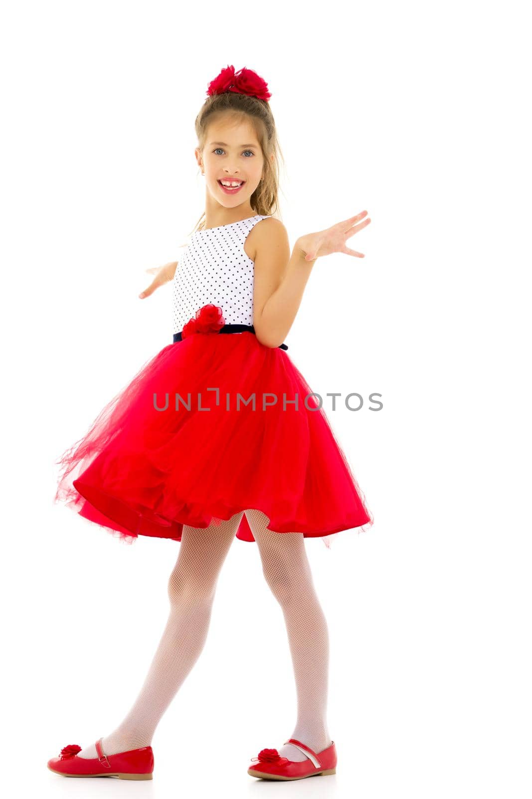 Beautiful little girl in an elegant dress in full growth. The concept of style and fashion. Layout for magazine cover. Isolated on white background.