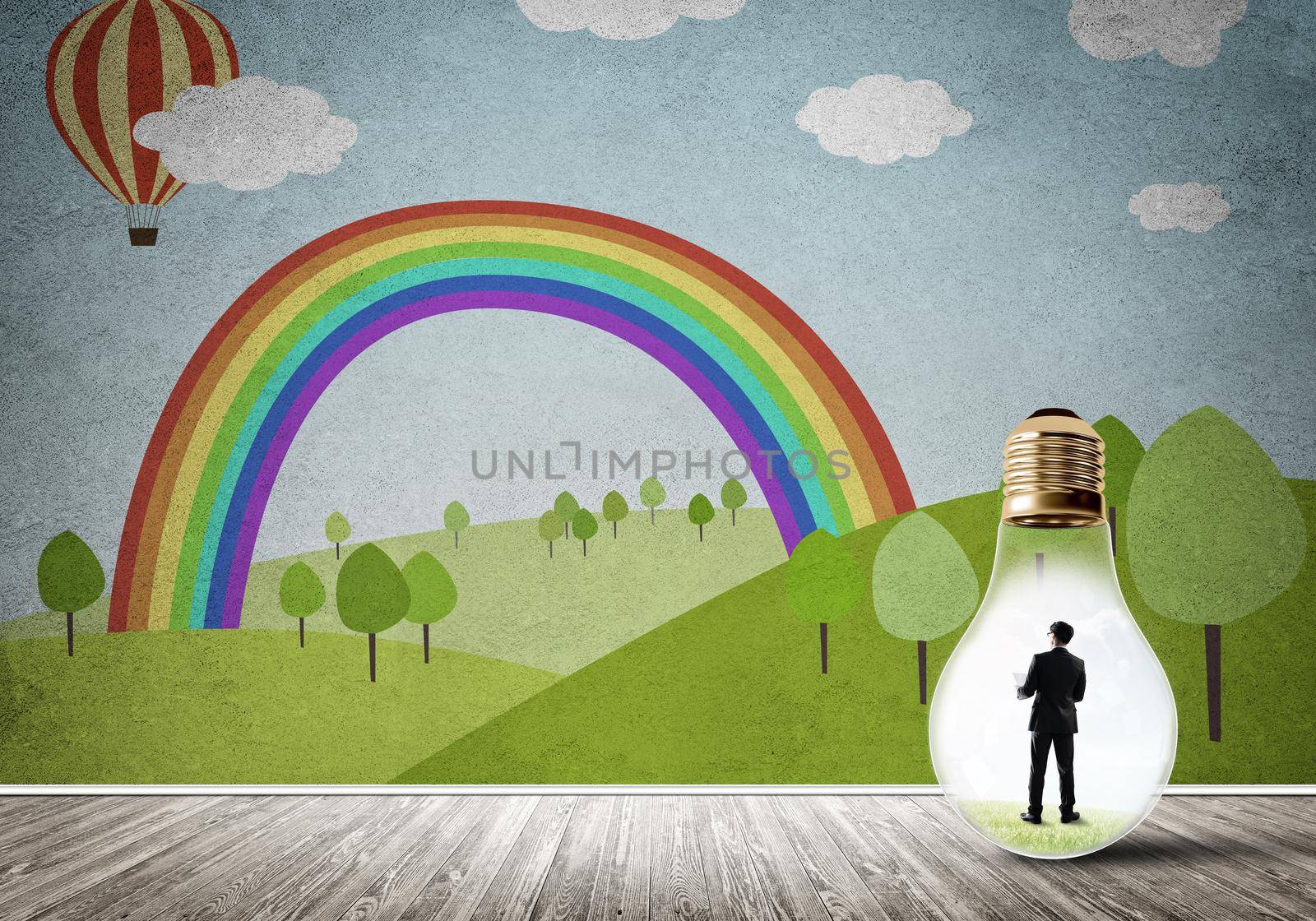 Businessman inside light bulb in room against nature drawn concept