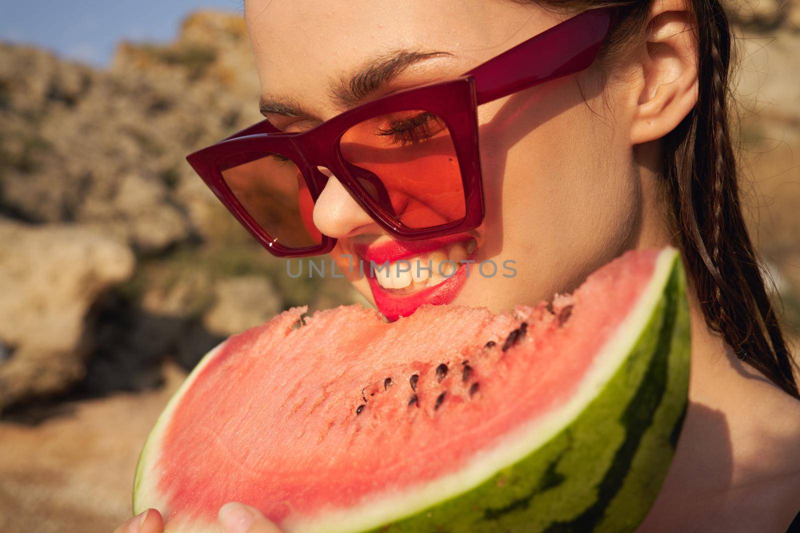 Cheerful woman eating watermelon nature summer vacation. High quality photo