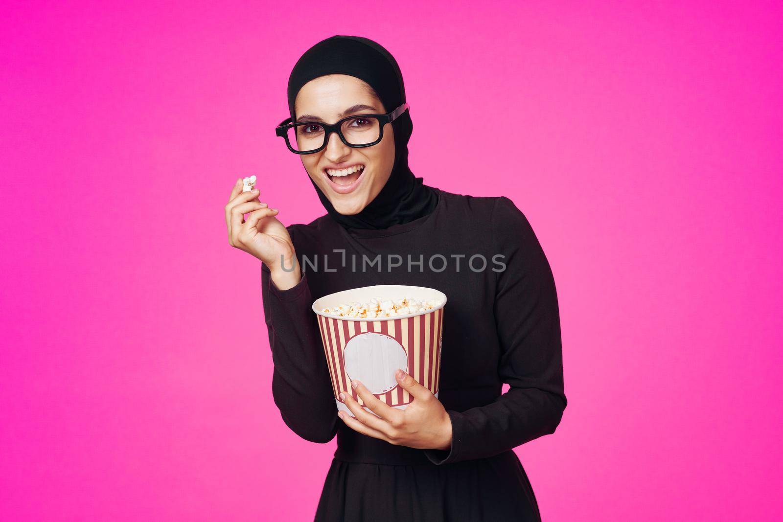 arab woman attractive look popcorn glasses movie watching isolated background. High quality photo