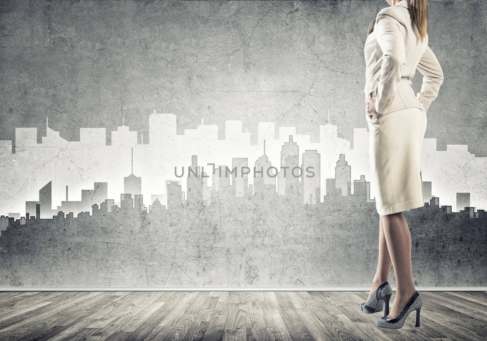 Bottom view of businesswoman and sketches of construction project on wall