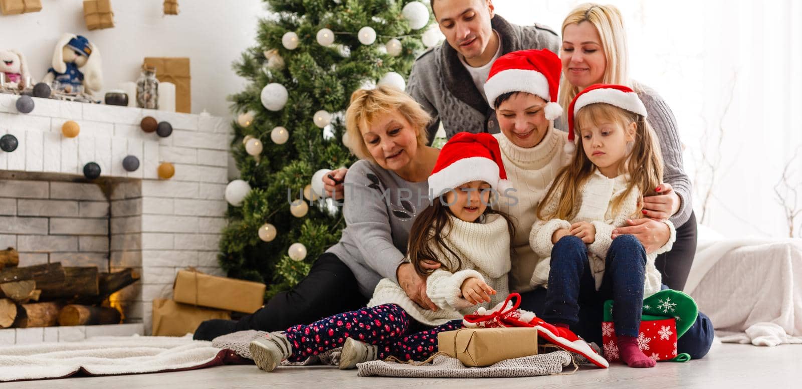 happy young family holding christmas gift and smiling.