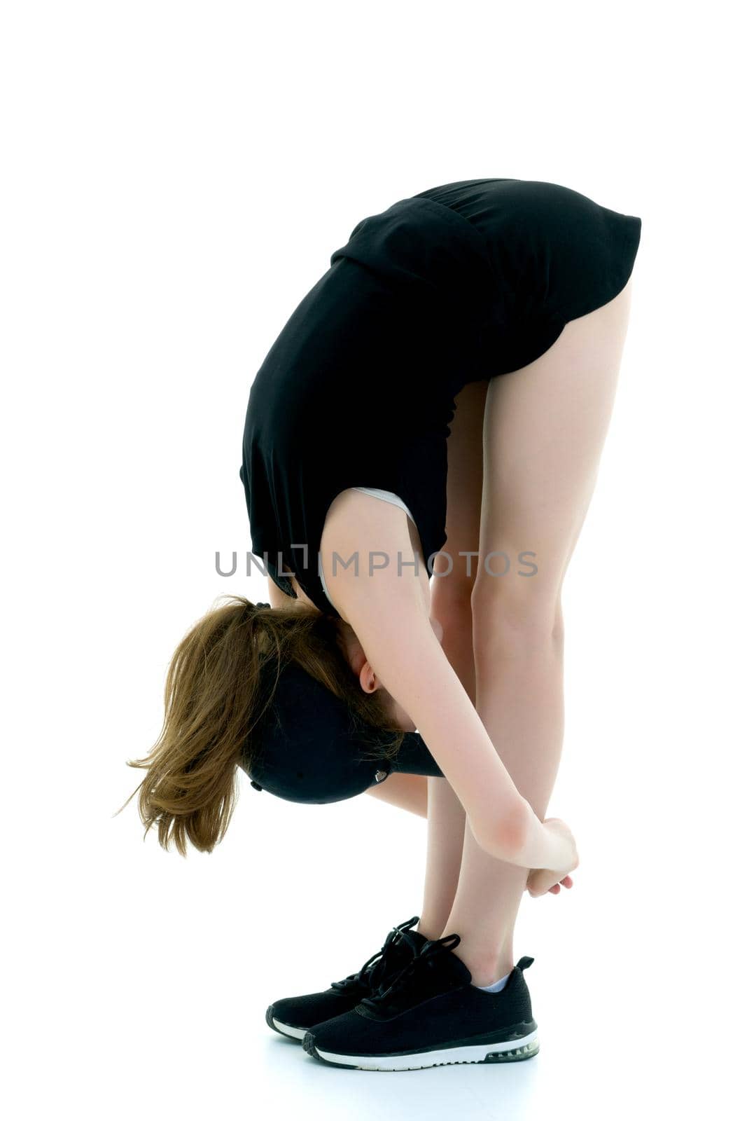 A teenage girl is engaged in fitness. She performs various exercises. The concept of childhood, sport, a healthy lifestyle. Isolated on white background.