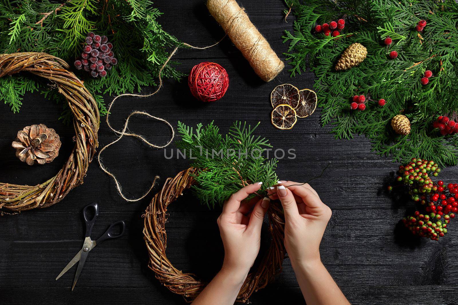 Manufacturer of Christmas decor with their own hands. Christmas wreath for the holiday. The new year celebration. Master class on making decorative ornaments. Top view. Flat lay