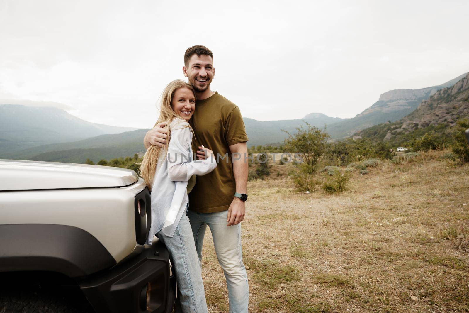 Young couple is on romantic trip to the mountains by car, close up