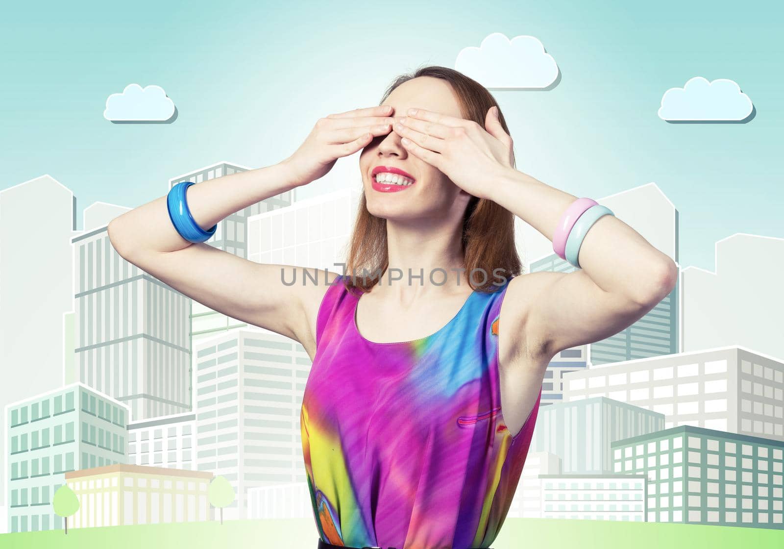Redhead beautiful girl closing her eyes with hands. Charming lady wears bright dress and bracelets standing on background cartoon cityscape. Portrait of happy young woman waiting for pleasant surprise