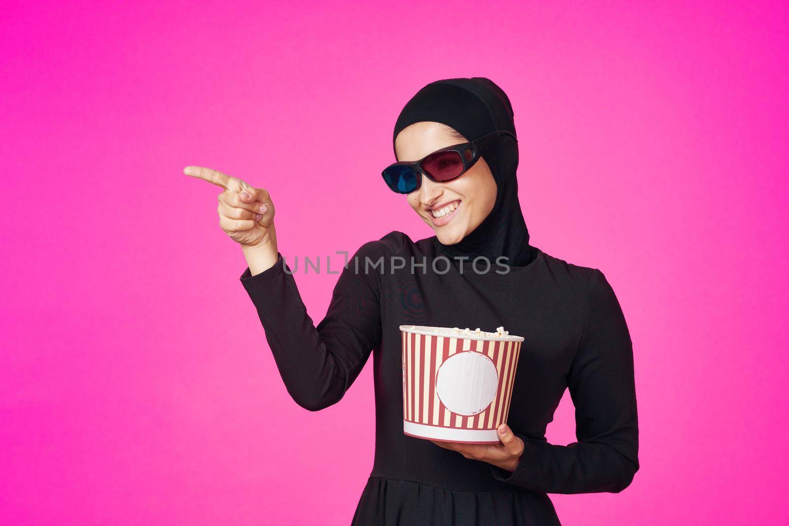 arab woman attractive look popcorn glasses movie watching isolated background. High quality photo