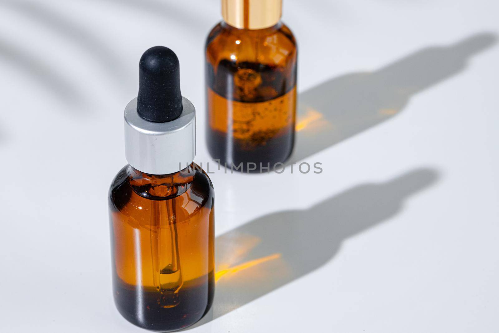 Oily skincare moistrizing brown glass jar with pipette close up