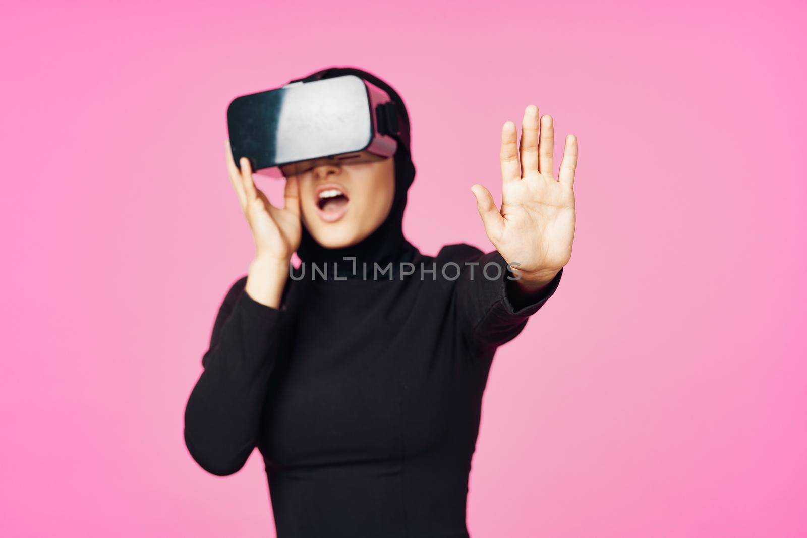 muslim woman wearing virtual reality glasses entertainment technology device by Vichizh