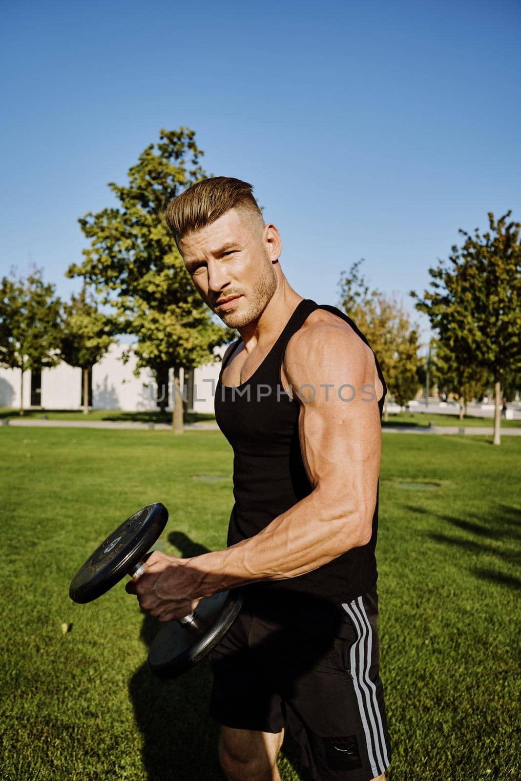 sporty man in black t-shirt in the park training lifestyle. High quality photo