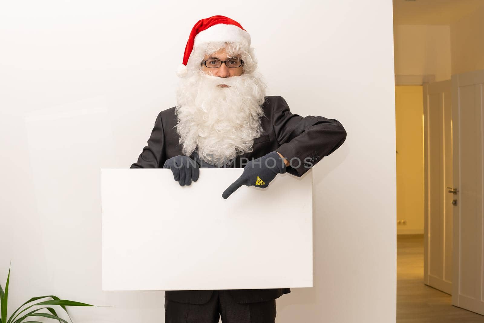 Santa Claus indicating something a white poster