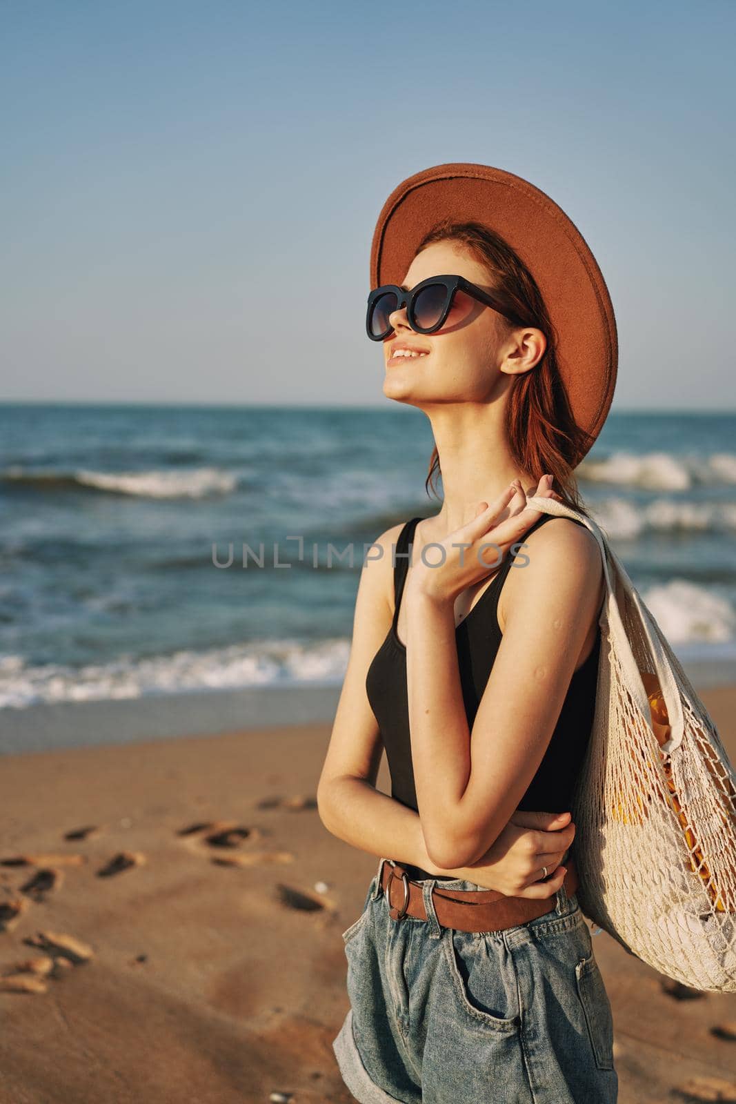 woman walking on the beach landscape sun fun lifestyle. High quality photo