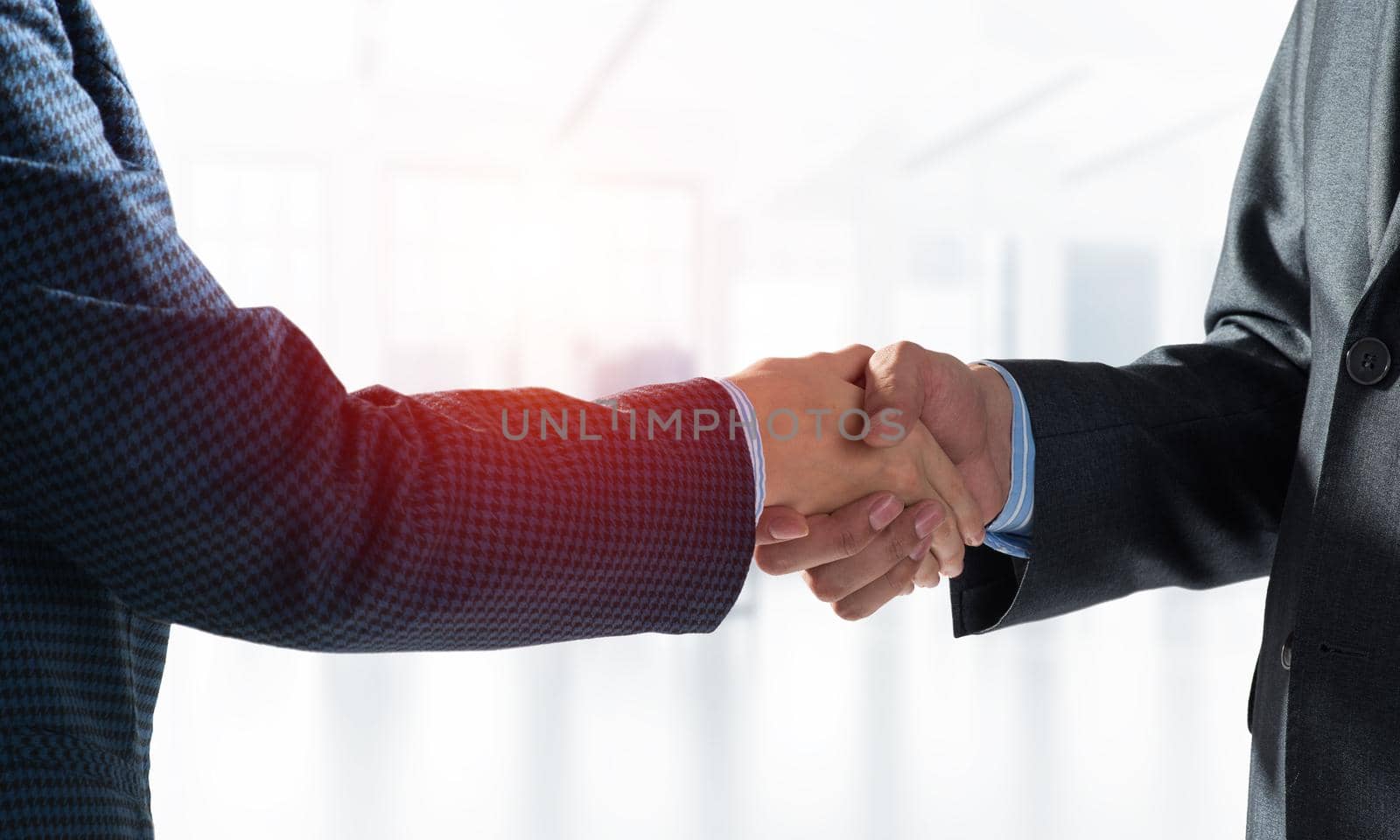 A close-up of a handshake. Making a deal between two businessmen