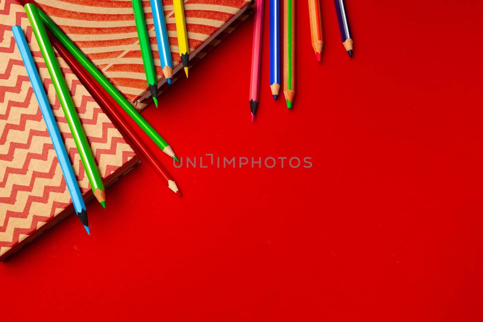 Notepad and color pencils, stationery on working space top view