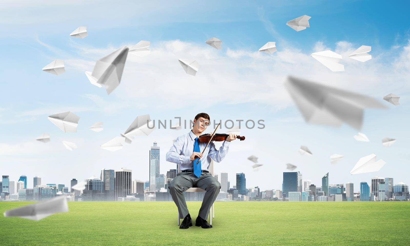 young businessman is engaged in music, concept of creative chaos in business