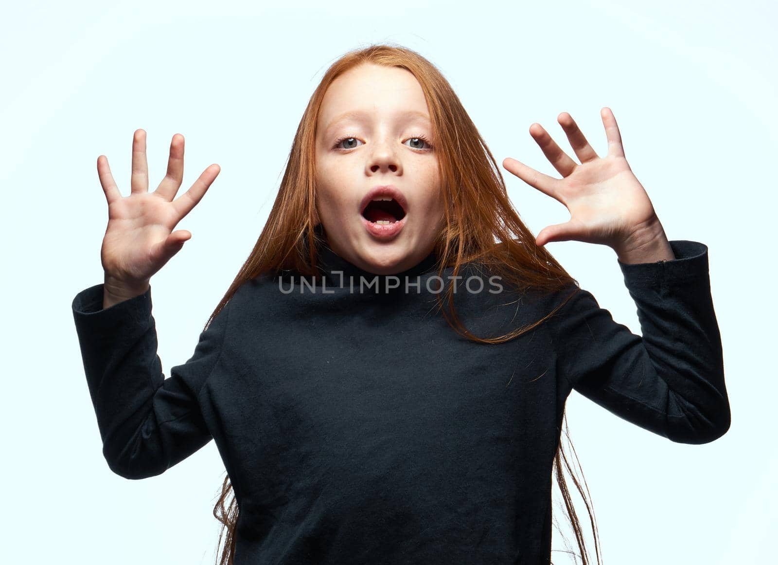 red-haired girl in a black sweater planning close-up. High quality photo