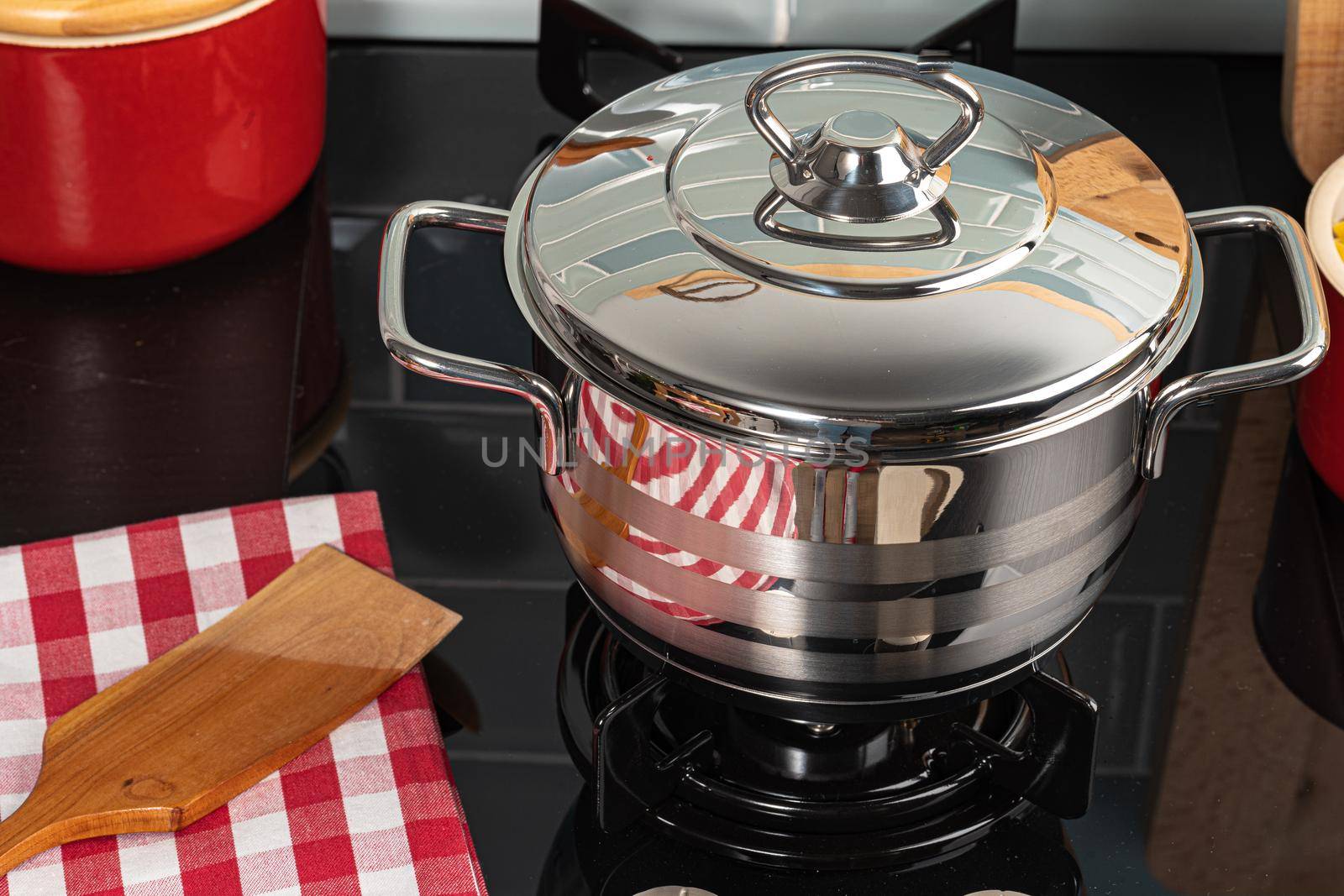 Metal pot on a gas stove burner at home kitchen close up
