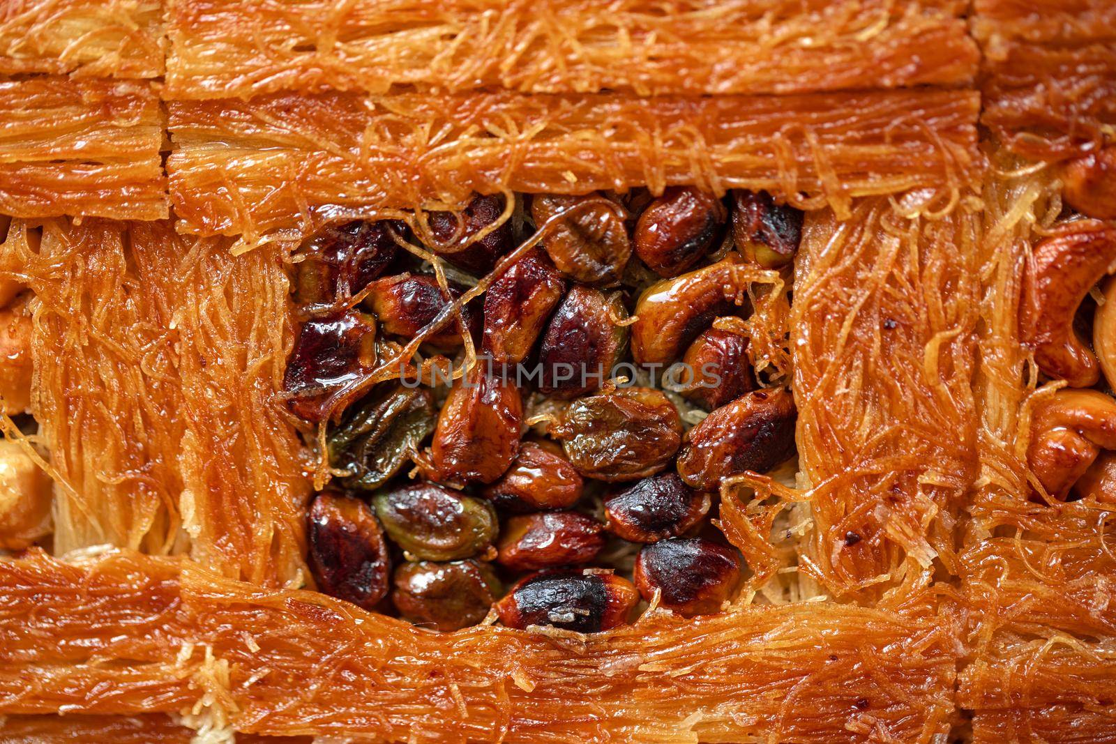Close up photo of Turkish Baklava dessert with honey and nuts
